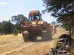 bulldozer travelling down track.